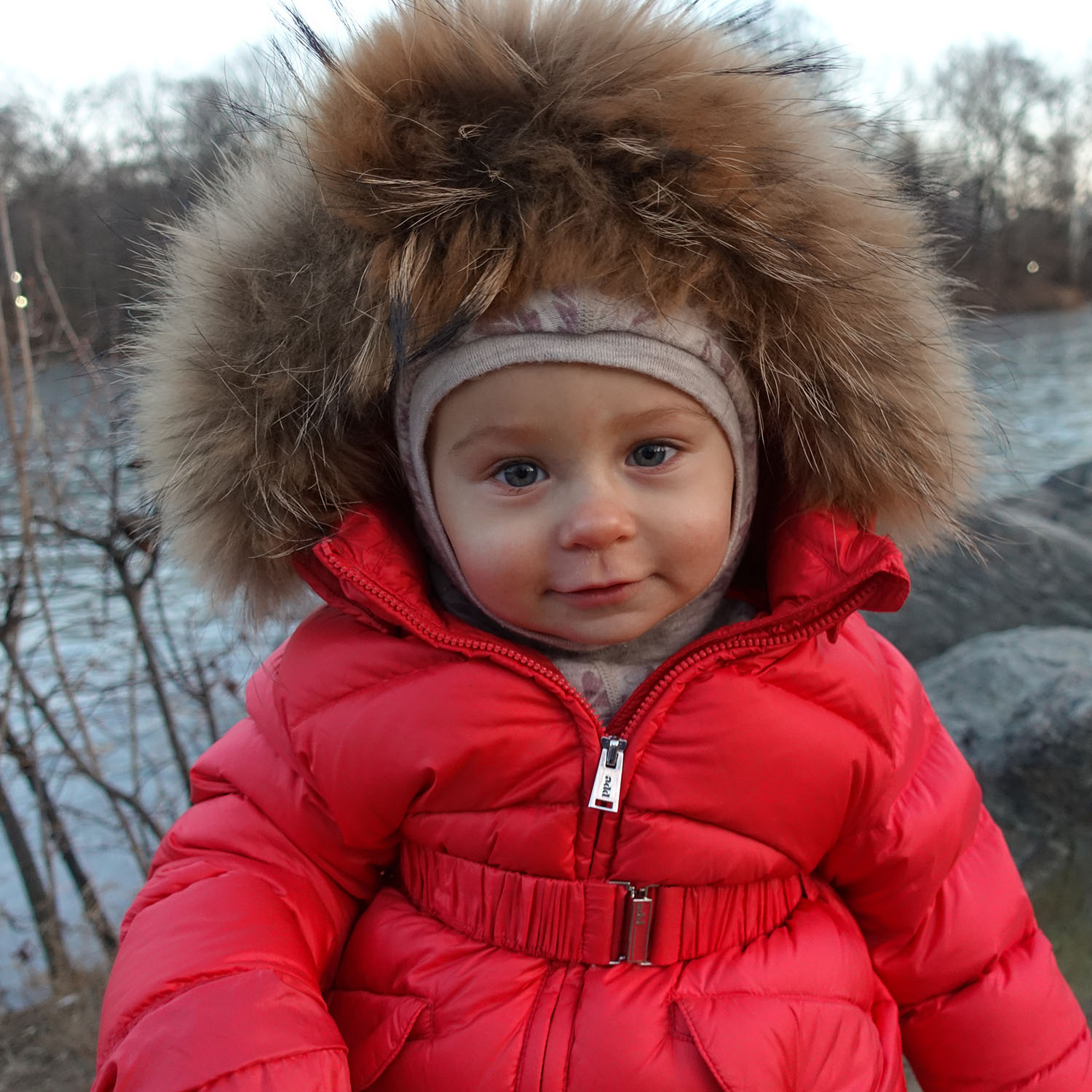 Anastasia in red coat, at twilight in Central Park