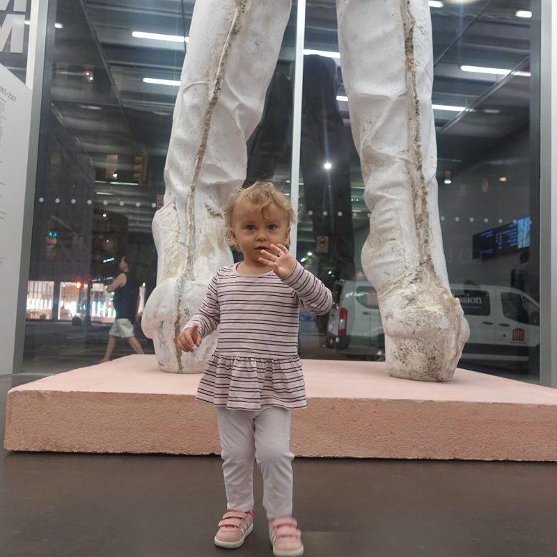 Anastasia Sudentas in New Museum, with Sarah Lucas's sculpture